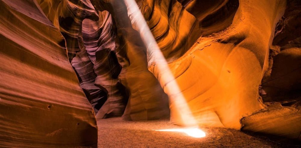 Light reaching through to the red canyon floor