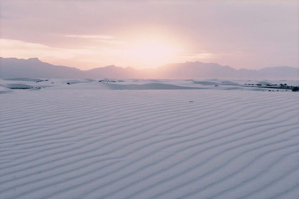 Pink sunset over the sugar-white White Sands National Park, New Mexico — you find the best hotels near White Sands National Park just a short drive away