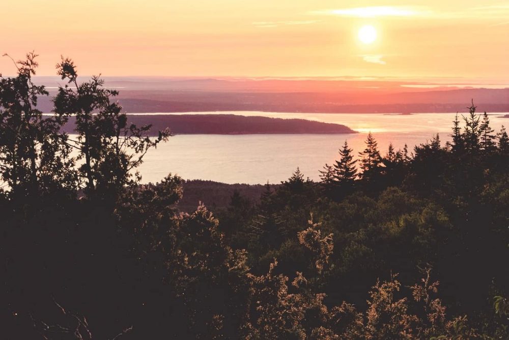 The sun setting over Acadia National Park, seen from the top of Cadillac Mountain