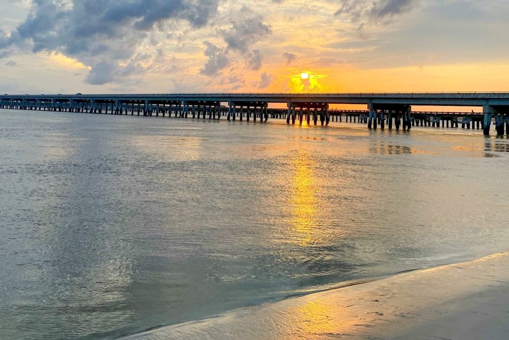 The sun setting over a bridge connecting Amelia Island to the mainland during sunset
