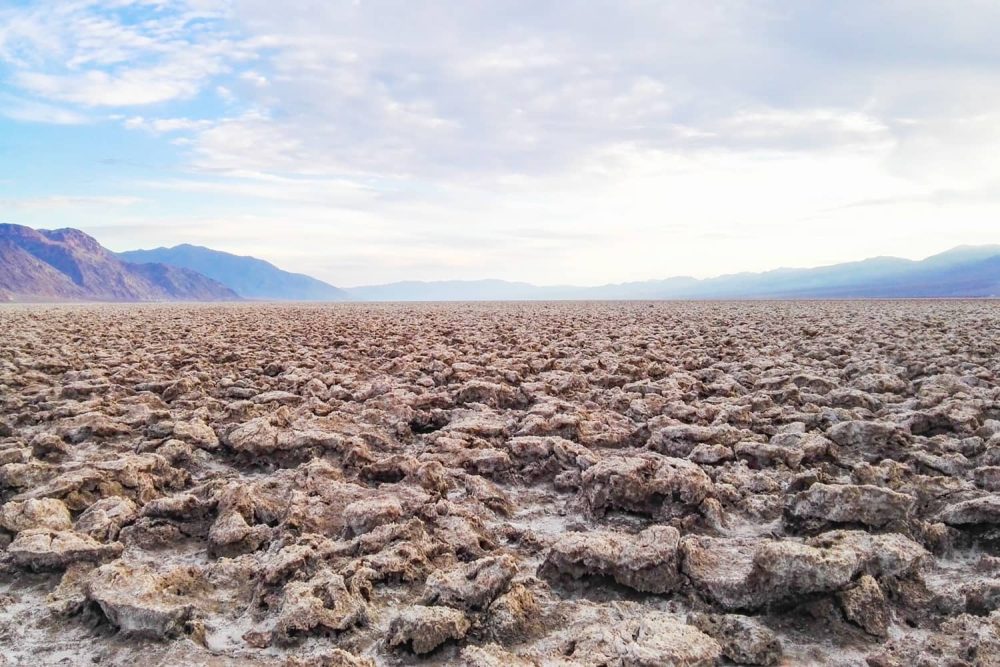 Vast expanses of jagged salt formations at Devils Golf Course during sunset