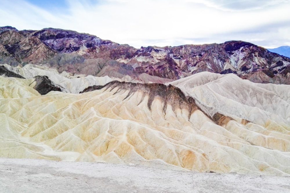 Bright badlands shaped wavy by powerful rainstorms at Zabriskie Point, Death Valley