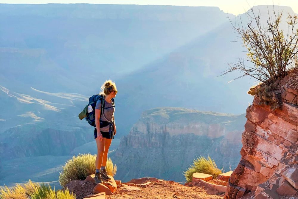 Girl on trail leading into the depths of Grand Canyon National Park