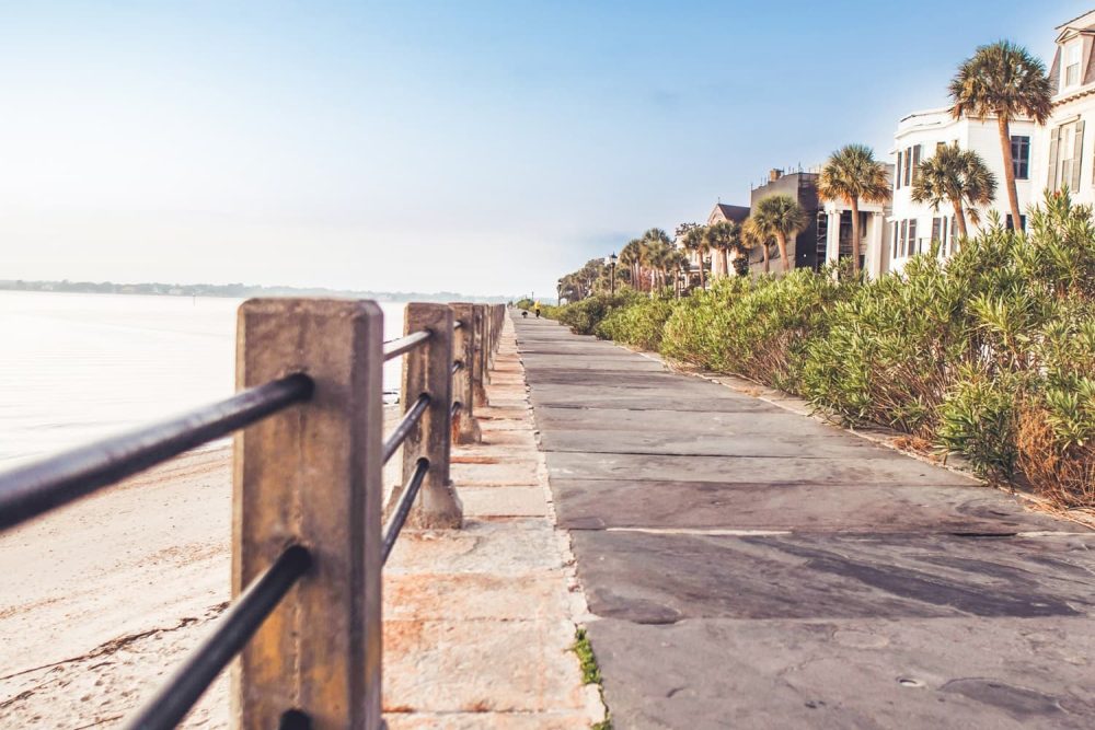 The Battery lined by stately mansions to the right and Charleston Harbour to the left
