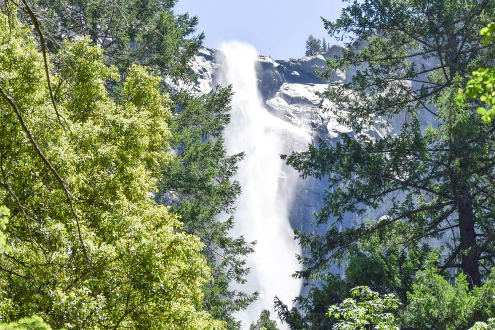 Water cascading over the brink of a waterfall and into Yosemite Valley